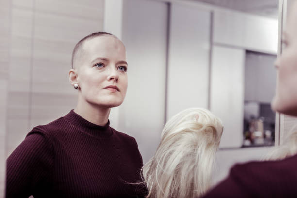 istock Concentrated young female looking at big mirror 1095557374