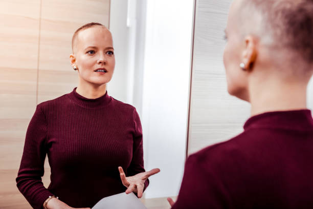 istock Positive delighted woman talking to her reflection 1095557460