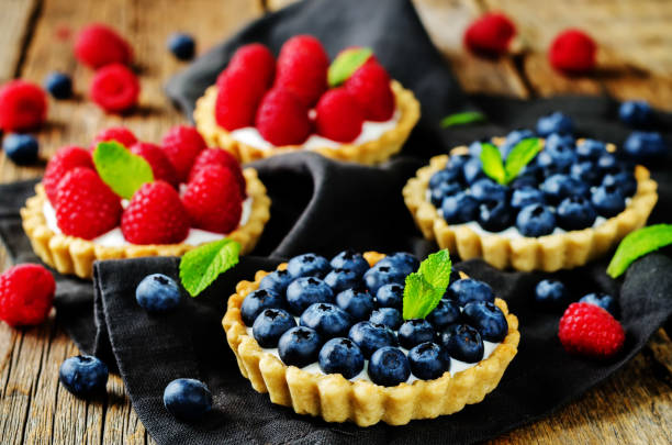 istock Raspberry and blueberry tartlets with fresh berries and mint leaves 1095569256