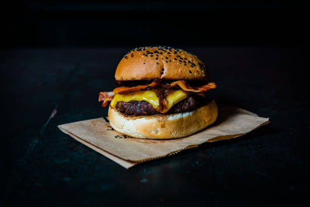 istock Tasty burger on wooden table 1095572098