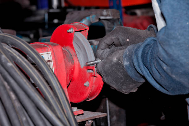istock A worker wears a piece of iron with the grinder 1095572588