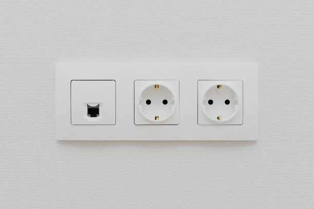 istock a socket on a light  wall, a multifunction outlet with an internet connection, two European-style outlets 1095572722
