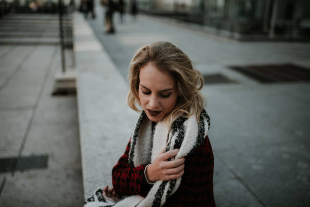 istock Young woman putting on a scarf 1095573130