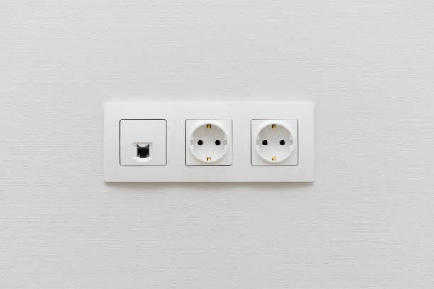 istock a socket on a light  wall, a multifunction outlet with an internet connection, two European-style outlets 1095574788