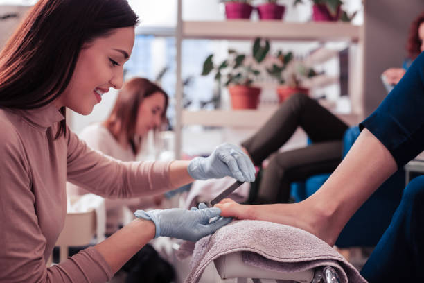 istock Pleasant young nail master enjoying her job 1095594396