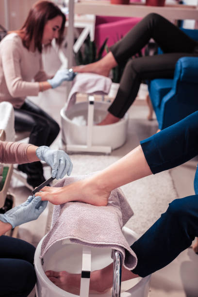istock Nice skilled woman correcting the shape of her clients nails 1095594438