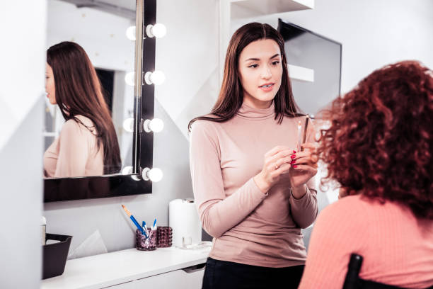 istock Pleasant dark haired woman looking at her client 1095595150