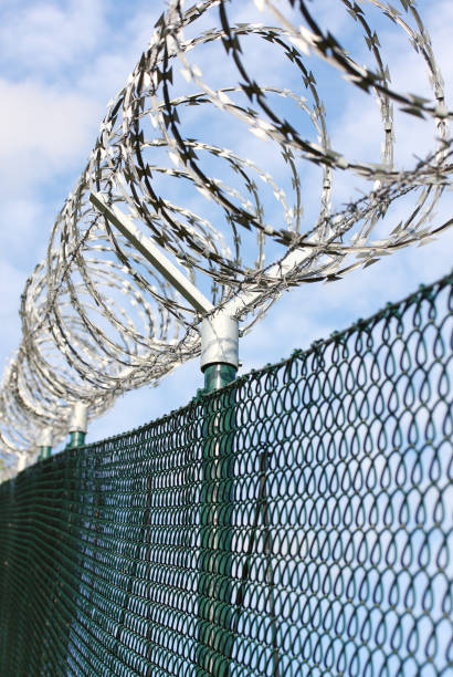 istock Barbed wire fence on state border or restricted area. 1095596292