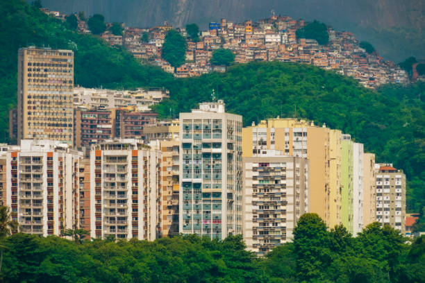 Expensive buildings in front of Lagoa Rodrigo de Freitas and  a favela in the background