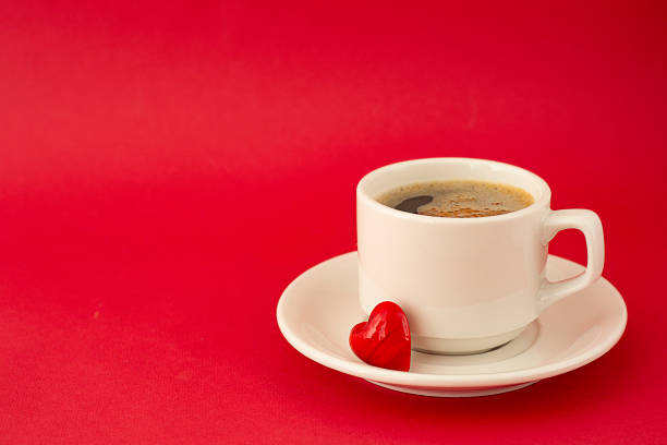 istock Cup of coffee isolated on red background. View from above. Web design, poster, invitation card. Valentine's Day concept. 1095599424