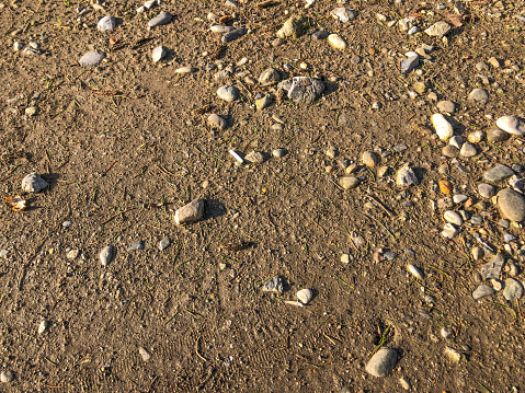 Gravel, pebbles and sand closeup seamless background.
