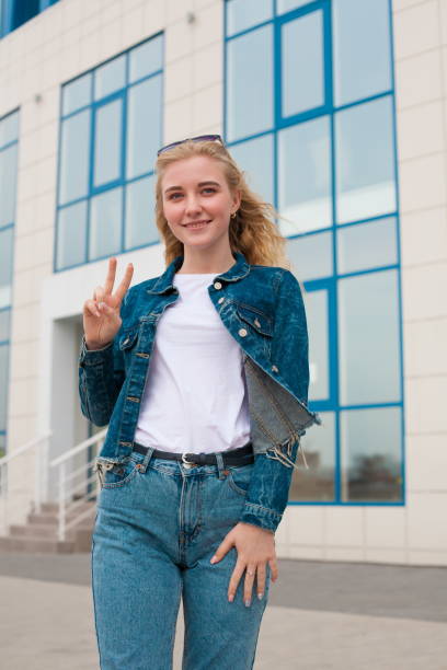 istock Girl, jeans and jacket, fun, close up, building background 1095603868