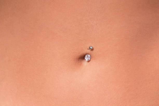 istock Belly piercing in the navel close up 1095605124