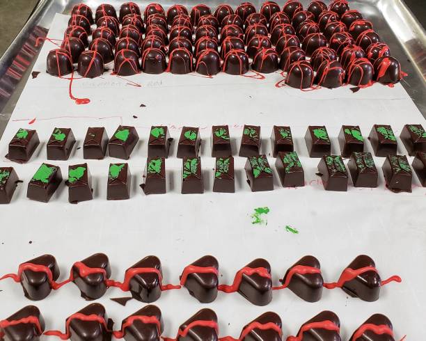 istock Handmade artisanal chocolate truffles decorated and ready for packaging. 1095605486