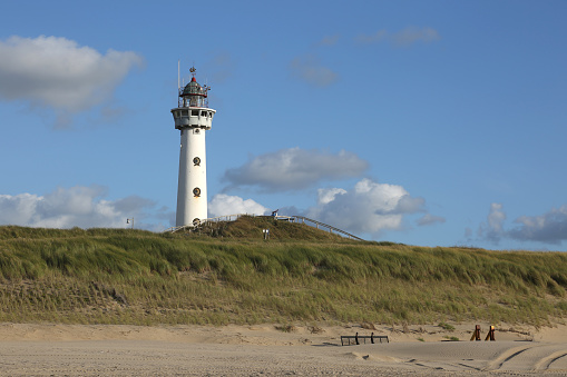 Dutch lighthouse in front of an beautiful blue and cloudy sky