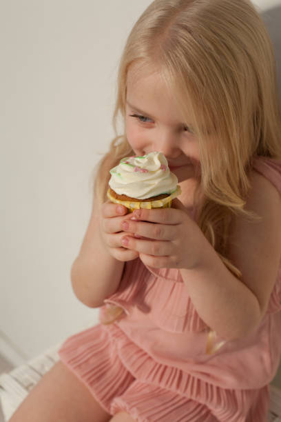 istock small girl in hand holds a sweet cupcake cake 1095609236