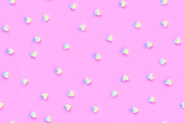 Pink repeating background with hearts in trendy colors. Seamless pattern.