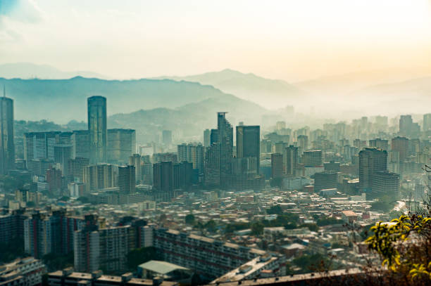tilt shift landscape of caracas during hazy, dark moody day with pollution, at sunset stock photo