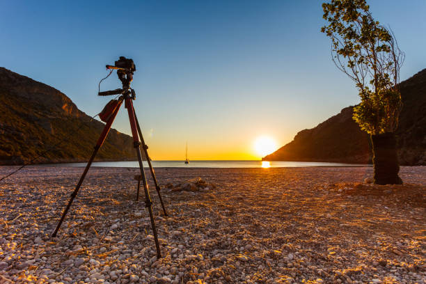 istock Camera taking picture of sunrise over sea surface 1095634362