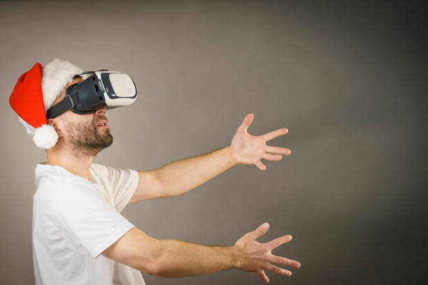 istock Man in virtual reality goggles and santa hat 1095634756