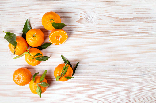 delicious mandarines/oranges on a white wooden table/background
