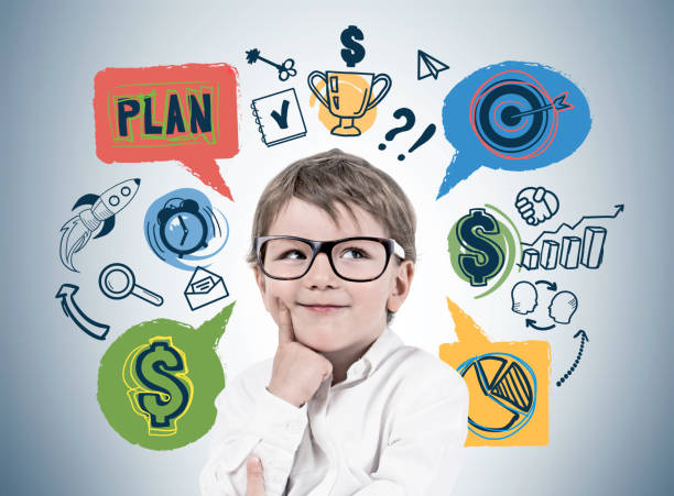 istock Little boy thinking about business plan 1095645104