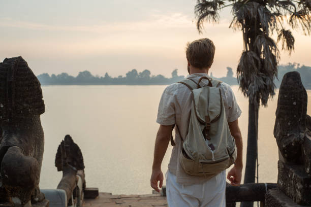istock Young man contemplating ancient temple in Cambodia 1095667222