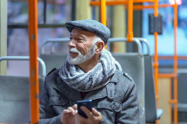 mature man riding in a bus - bus riding public transportation businessman imagens e fotografias de stock