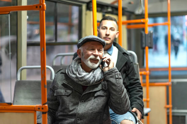 mature man riding in a bus - bus riding public transportation businessman imagens e fotografias de stock