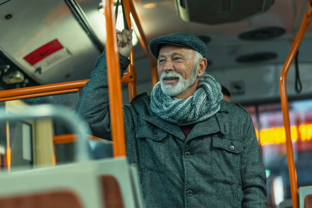 mature man riding in a bus - bus riding public transportation businessman imagens e fotografias de stock