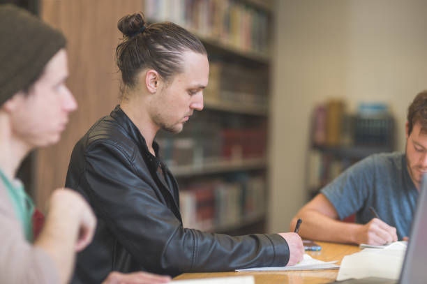 istock College students studying in the university library 1095677556