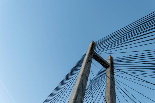 Modern cement bridge pylon structure over clear blue sky. stock photo