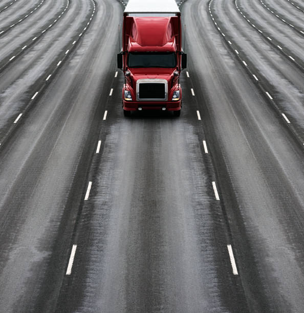 A semi truck on a multiple lane highway.