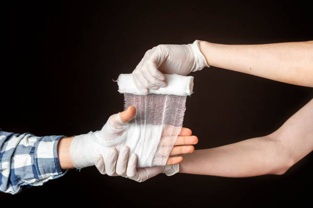 istock applying bandage on hand. injure treat b 1095687962
