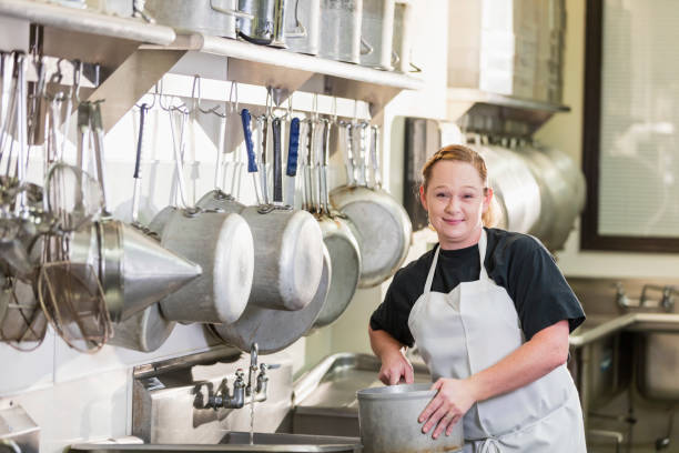 istock Woman working in commercial kitchen 1095688196