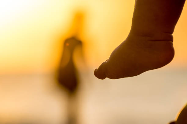 Focus on diverse feet and toes enjoying a day on the beach