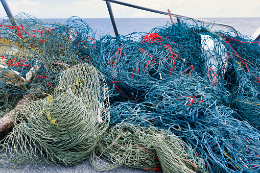 Here we see the fruits of an environmental cleanup in the Ocean.  ‘Ghost Nets’ are the term now used for abandoned or obsolete items from the fishing industry, which become dangerous garbage polluting the Ocean.  Ghost Nets are responsible for the deaths of huge amounts of Marine Life every year, through entanglement and consumption.  The location is near Phi Phi islands in the Andaman Sea, Krabi, Thailand.