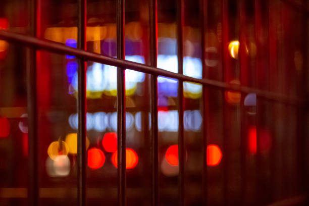 istock Urban night illumination background with artificially blurred neon and led lighting of buildings and roads with retro noise effects and warm colors of headlights. 1095726150