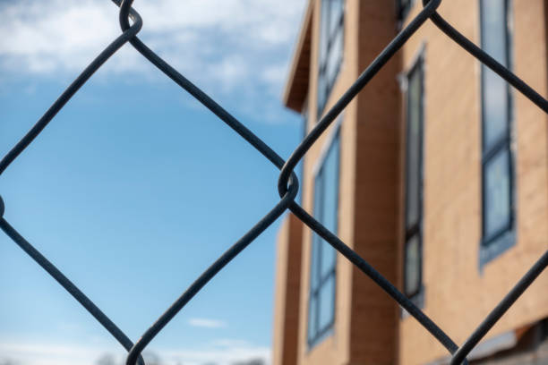 istock New Home Construction View Through a Fence 1095731940