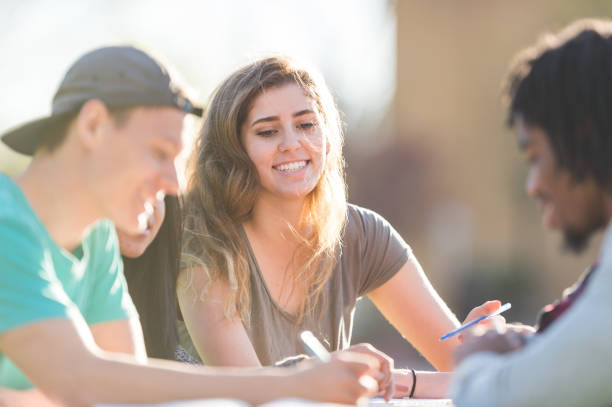 istock College students studying at a picnic table outside 1095752816