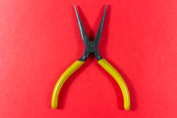 istock Pliers isolated on a red background 1095764416