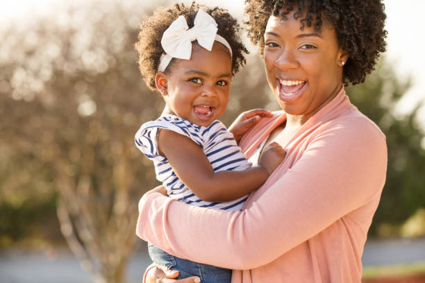 istock African American mother picking up her daughter. 1095773594