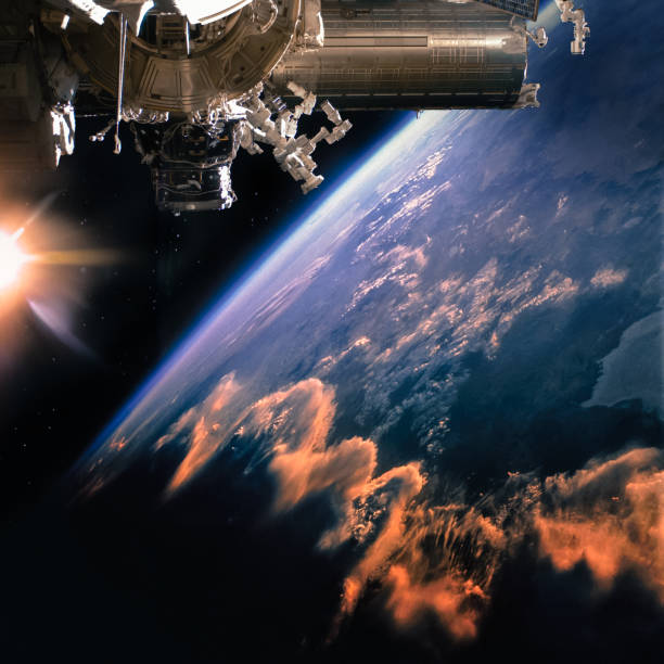istock Spaceship on the orbit. Earth with clouds sunshine on the background. Elements of this image furnished by NASA. 1095780850