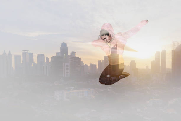 Picture of female dancer is dancing Dab while jumping with modern city background at sunrise time
