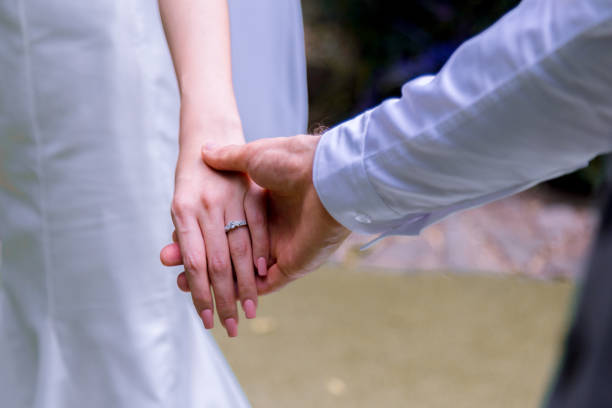 istock Bride and groom holding hands in wedding celemony. 1095795016