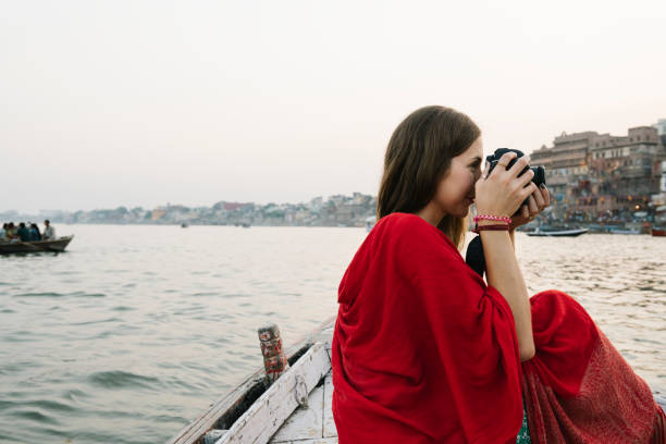istock Traveler on a boat taking photos from the River Ganges 1095803384