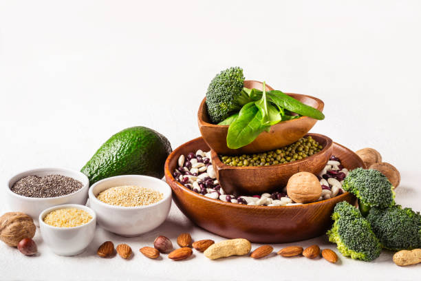 istock Diverse Sources of vegetable protein. Nuts, beans and broccoli on white background 1095808130