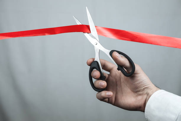 istock Man cutting red ribbon with scissors. 1095808852