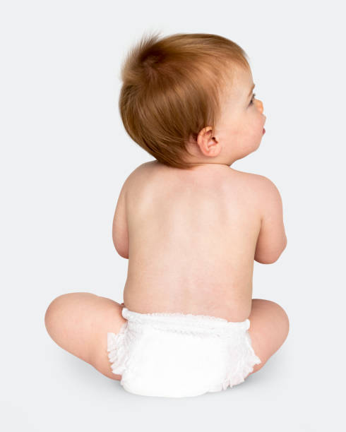 istock Baby in a diaper sitting on the floor 1095811064