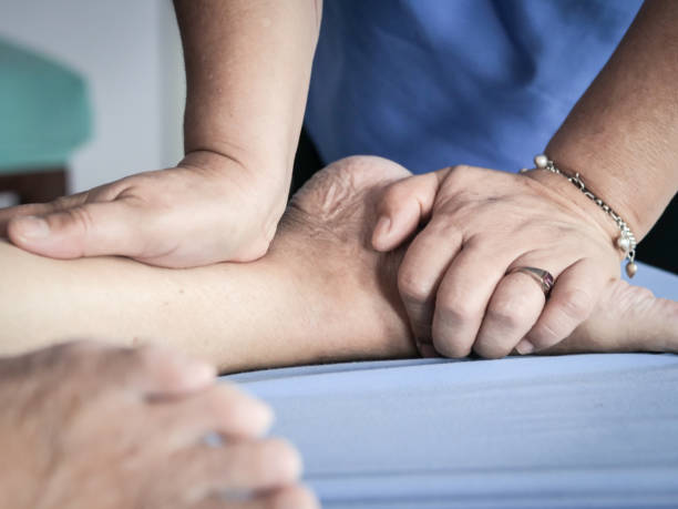istock senior lady having body and legs massage by therapist. 1095818208